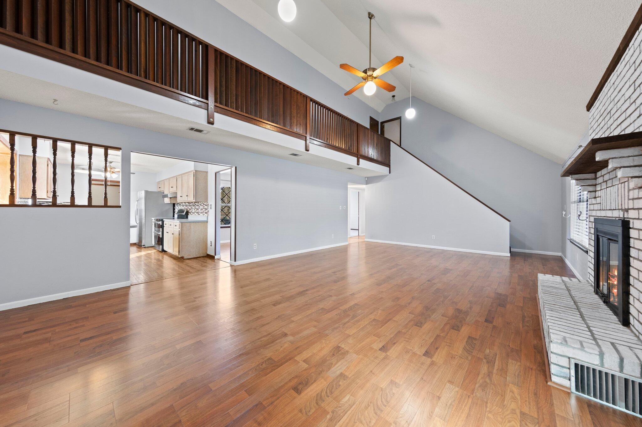 466 Olde Post Road Niceville, FL 32578 - Photo 7 of 49 a view of a livingroom with wooden floor and a staircase