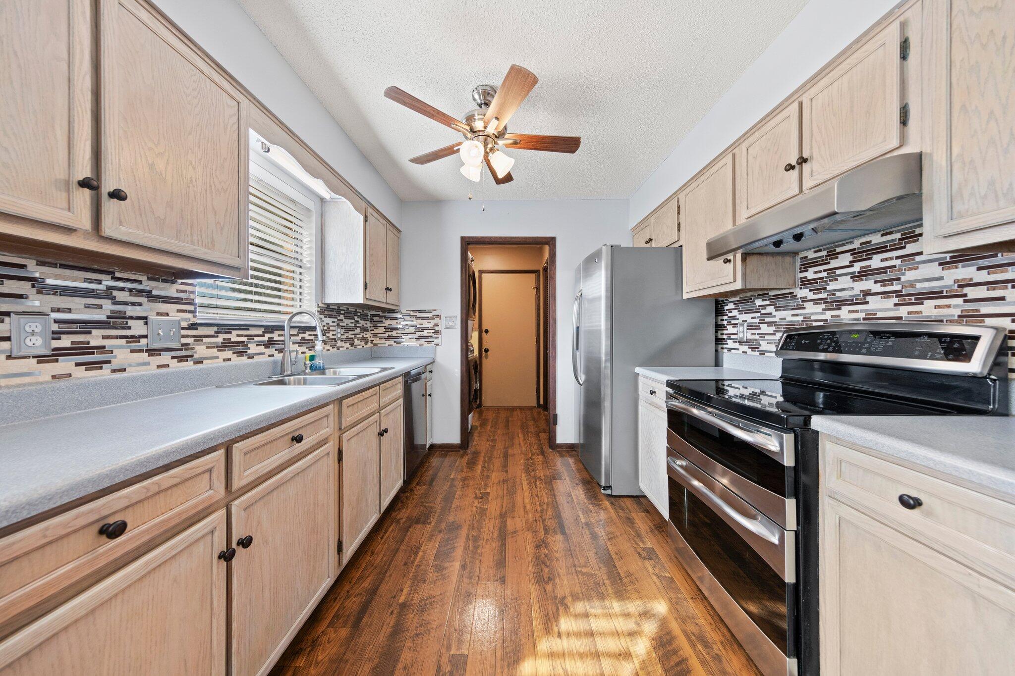466 Olde Post Road Niceville, FL 32578 - Photo 10 of 49 a kitchen with stainless steel appliances granite countertop hardwood floor sink stove and granite counter top