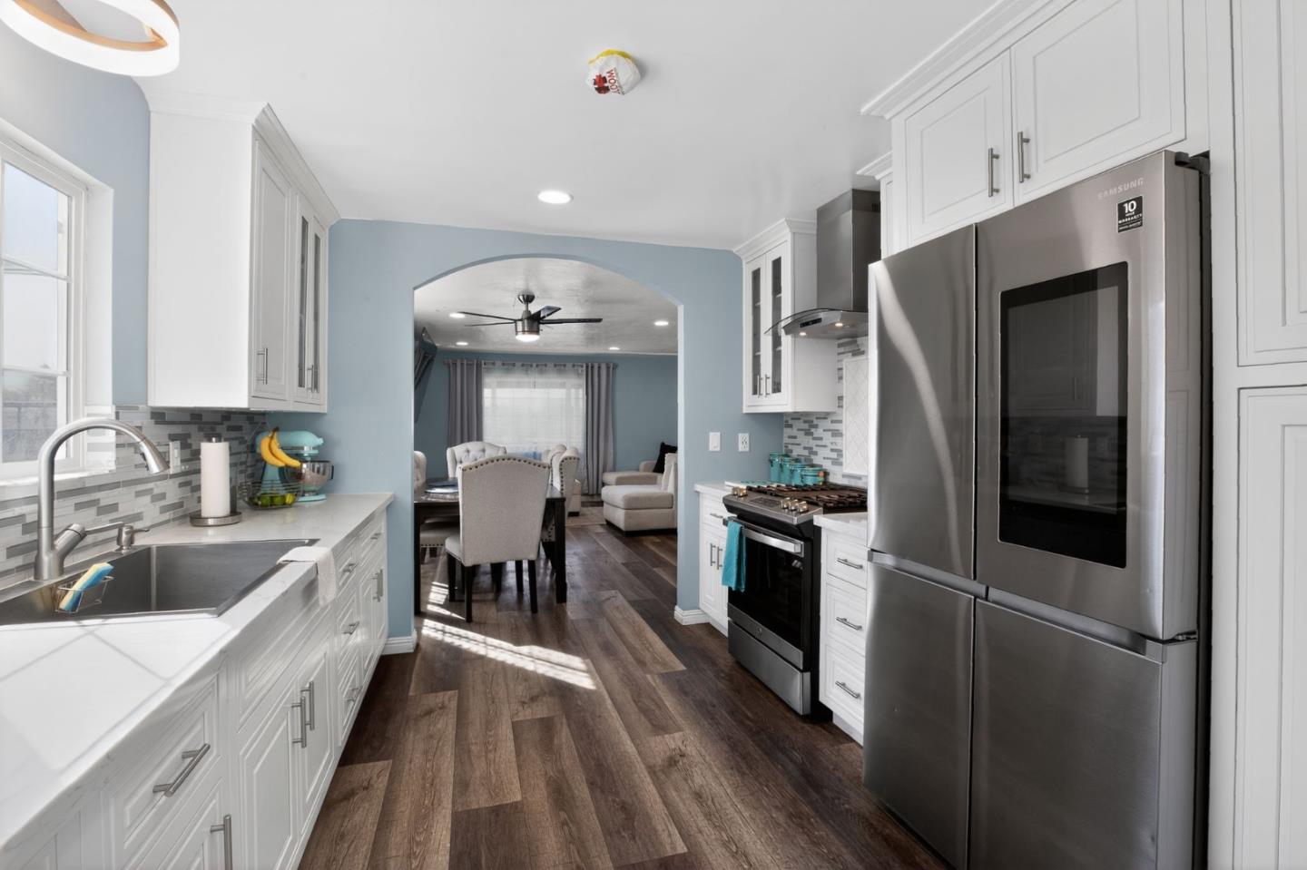 24 Amesti Road Watsonville, CA 95076 - Photo 12 of 27 a kitchen with stainless steel appliances granite countertop a refrigerator a sink dishwasher a stove and white countertops with wooden floor