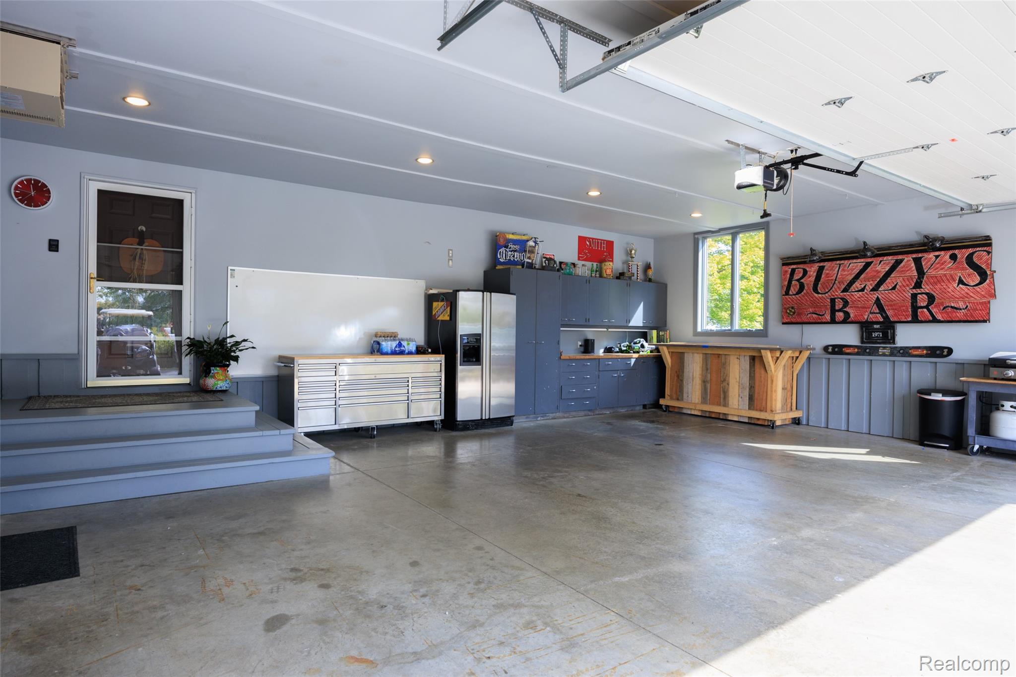 7030 Marsh Road Marine City, MI 48039 - Photo 42 of 47 Garage featuring stainless steel refrigerator with ice dispenser, recessed lighting, and a garage door opener