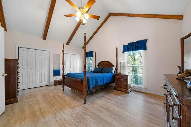 a bedroom with a bed and a chandelier
