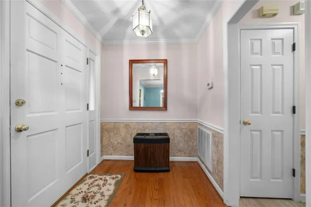 a view of a hallway with wooden floor and staircase