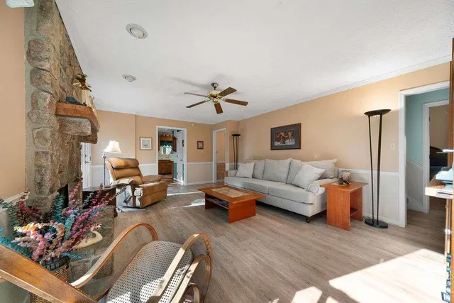 a living room with furniture and a chandelier