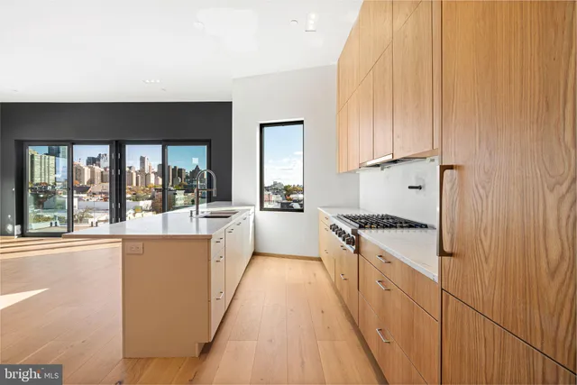a large kitchen with cabinets a sink and appliances