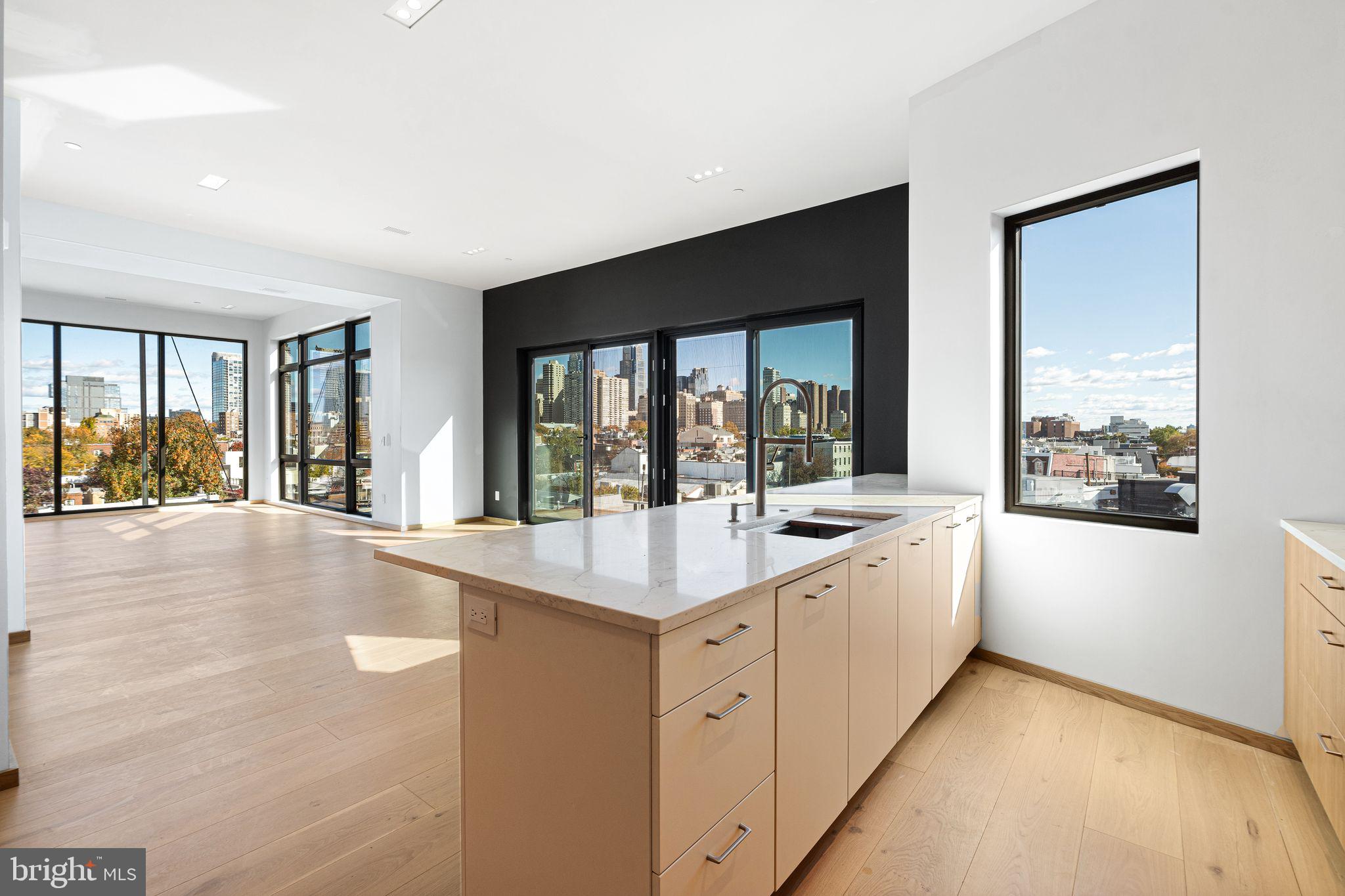 617 South 24th Street, Unit 501 Philadelphia, PA 19146 - Photo 13 of 36 a large white kitchen with a large window
