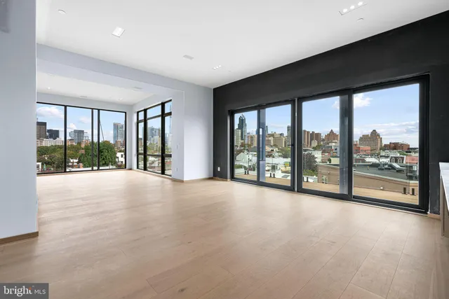 a view of an empty room with windows and a balcony
