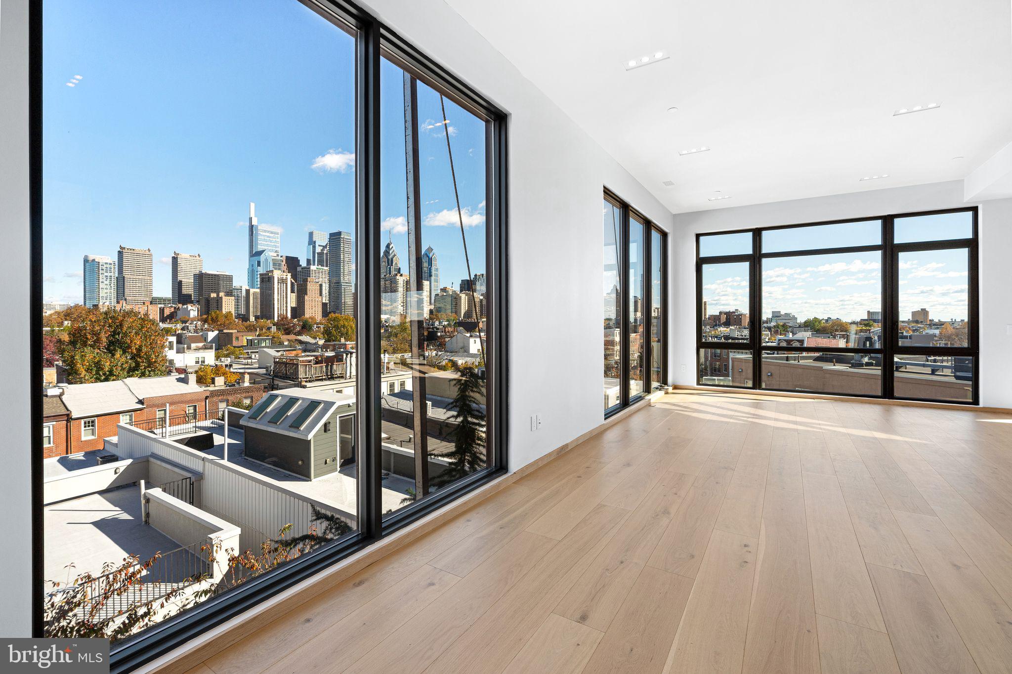 617 South 24th Street, Unit 501 Philadelphia, PA 19146 - Photo 2 of 36 an empty room with wooden floor and windows