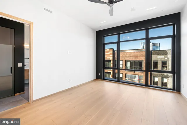 an empty room with floor to ceiling windows and an outdoor view