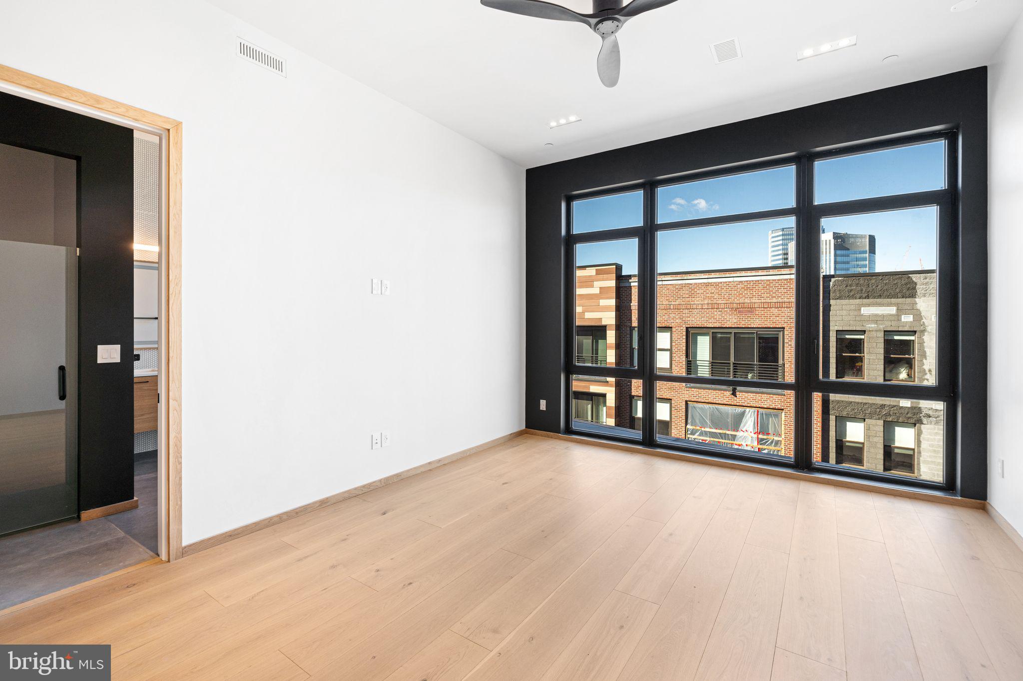 617 South 24th Street, Unit 501 Philadelphia, PA 19146 - Photo 21 of 36 an empty room with floor to ceiling windows and an outdoor view