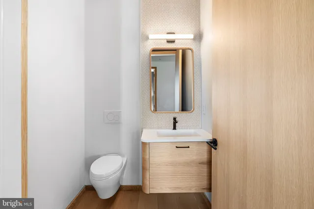 a bathroom with a toilet sink and mirror