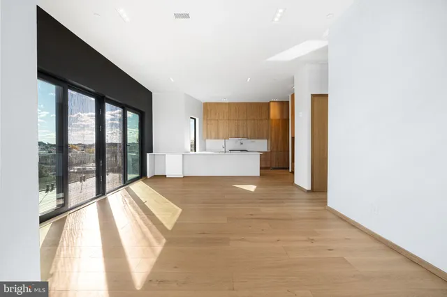 a spacious bedroom with a large bed and a large window