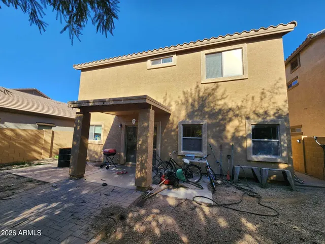 a view of a house with backyard and sitting area