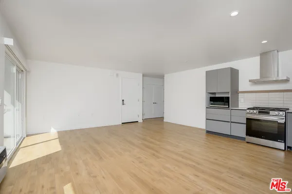 a view of a kitchen with a sink and a stove top oven