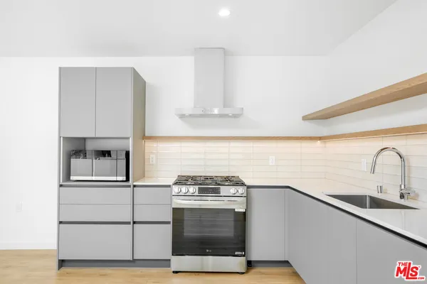 a kitchen with stainless steel appliances granite countertop a stove and a sink