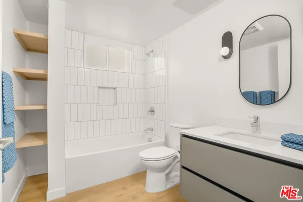 a bathroom with a toilet sink and shower