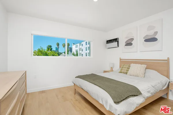 a bedroom with a bed and a window