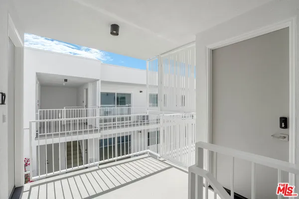 a balcony with furniture and a large window