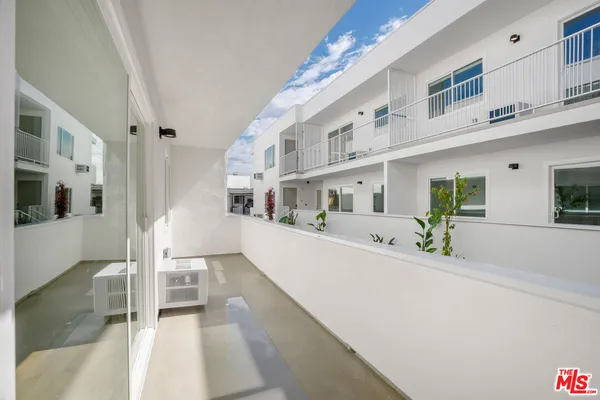 a view of a patio with a table and chairs