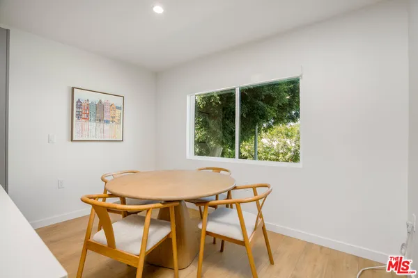 a view of a dining room with furniture and a window