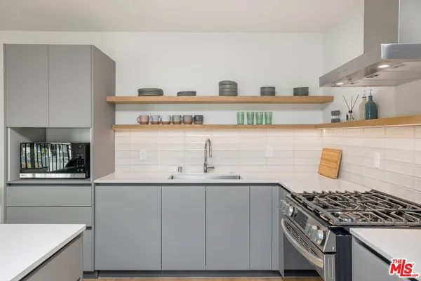 a kitchen with granite countertop a sink and a stove