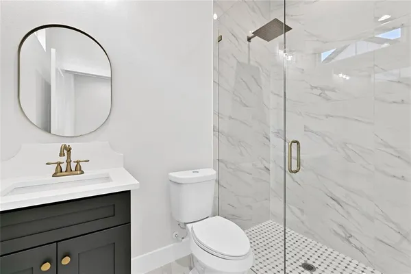 a bathroom with a sink toilet and a mirror