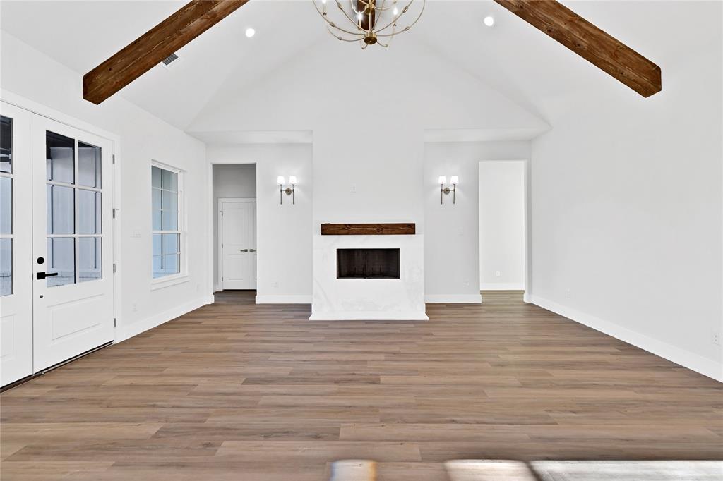 360 Dalton Road Canton, TX 75103 - Photo 16 of 23 a view of an empty room with wooden floor and a kitchen