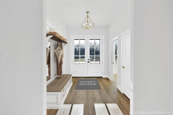 a view of a hallway view with wooden floor and staircase