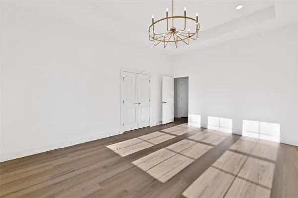 a view of a room with wooden floor and white walls