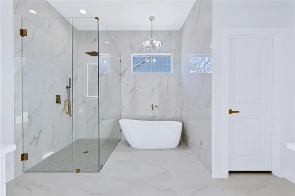 a bathroom with a bathtub and shower