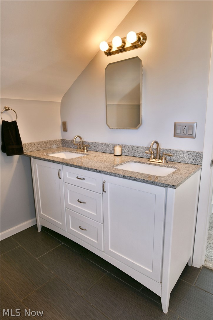 1525 Elm Road Northeast Warren, OH 44483 - Photo 23 of 50 Full bathroom featuring double vanity and vaulted ceiling