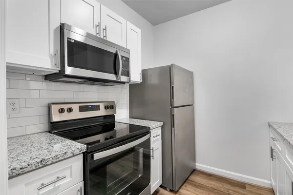 a kitchen with a stove microwave and refrigerator