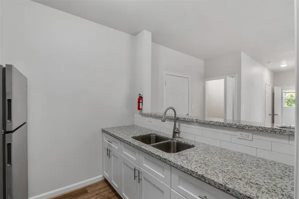 a kitchen with stainless steel appliances granite countertop a sink and a granite counter tops