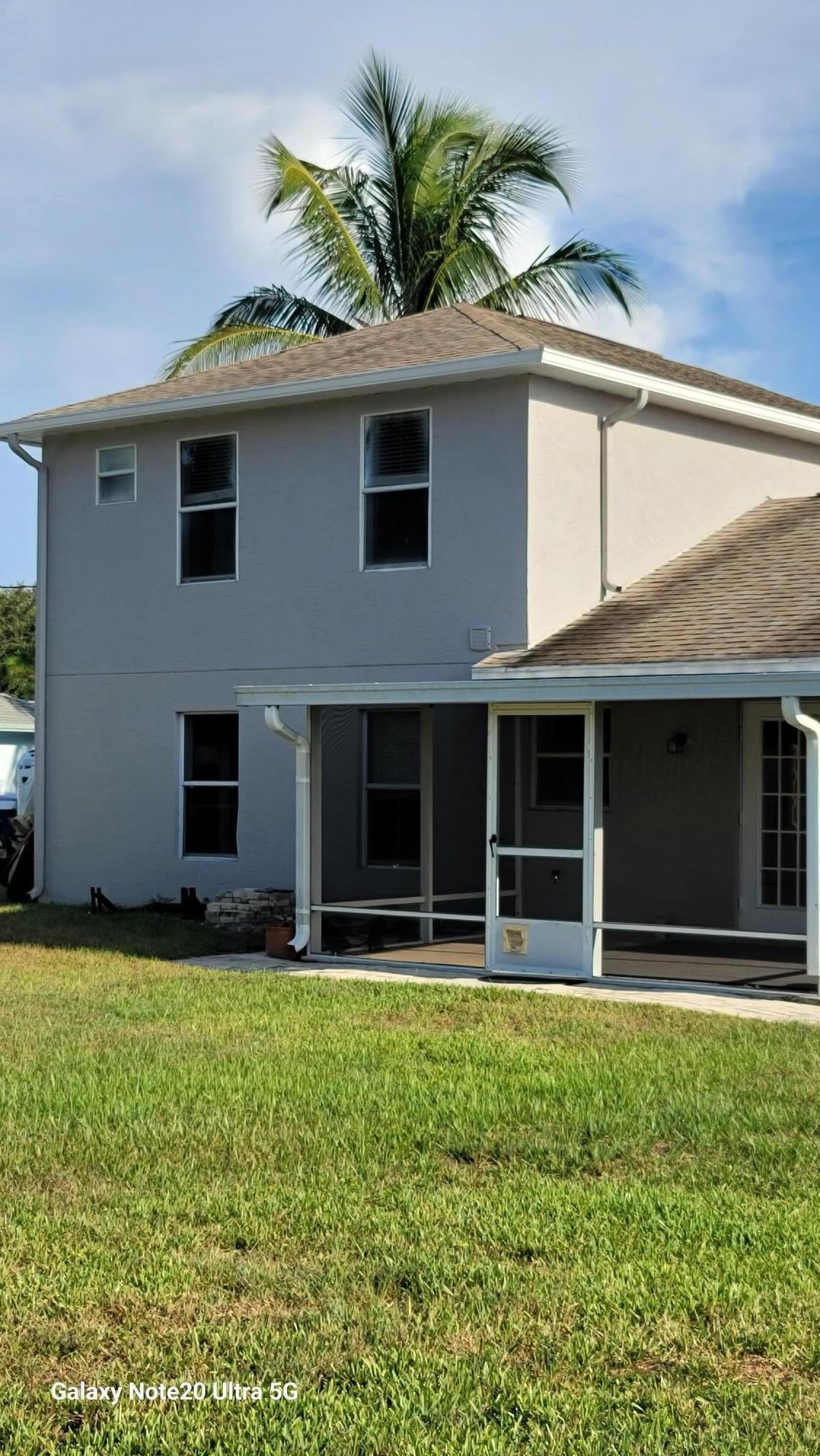 2581 Southeast Jason Avenue Port St. Lucie, FL 34952 - Photo 2 of 4 a front view of a house with a yard