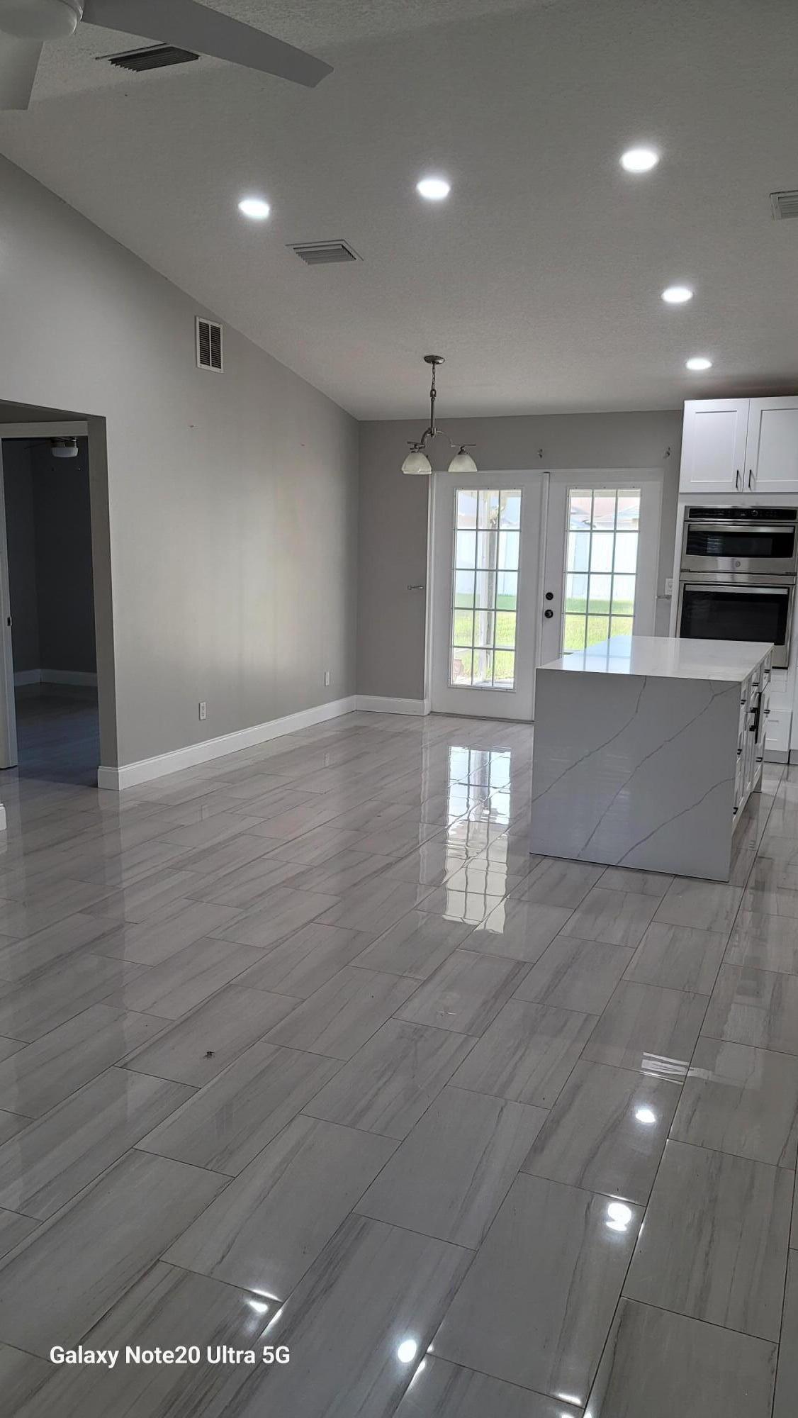 2581 Southeast Jason Avenue Port St. Lucie, FL 34952 - Photo 4 of 4 an empty room with wooden floor and windows