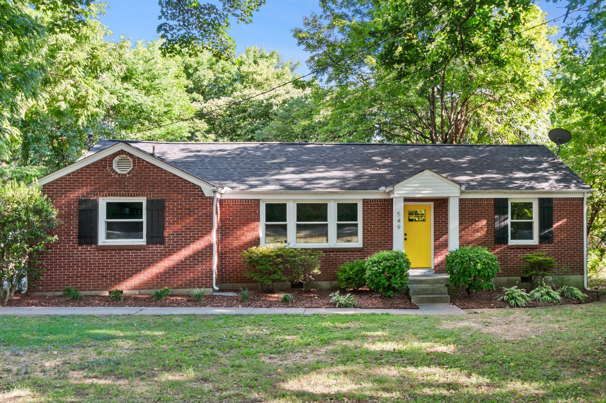 a front view of a house with a yard