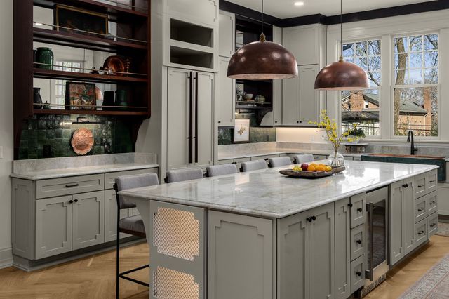 a living room with furniture a chandelier and a dining table