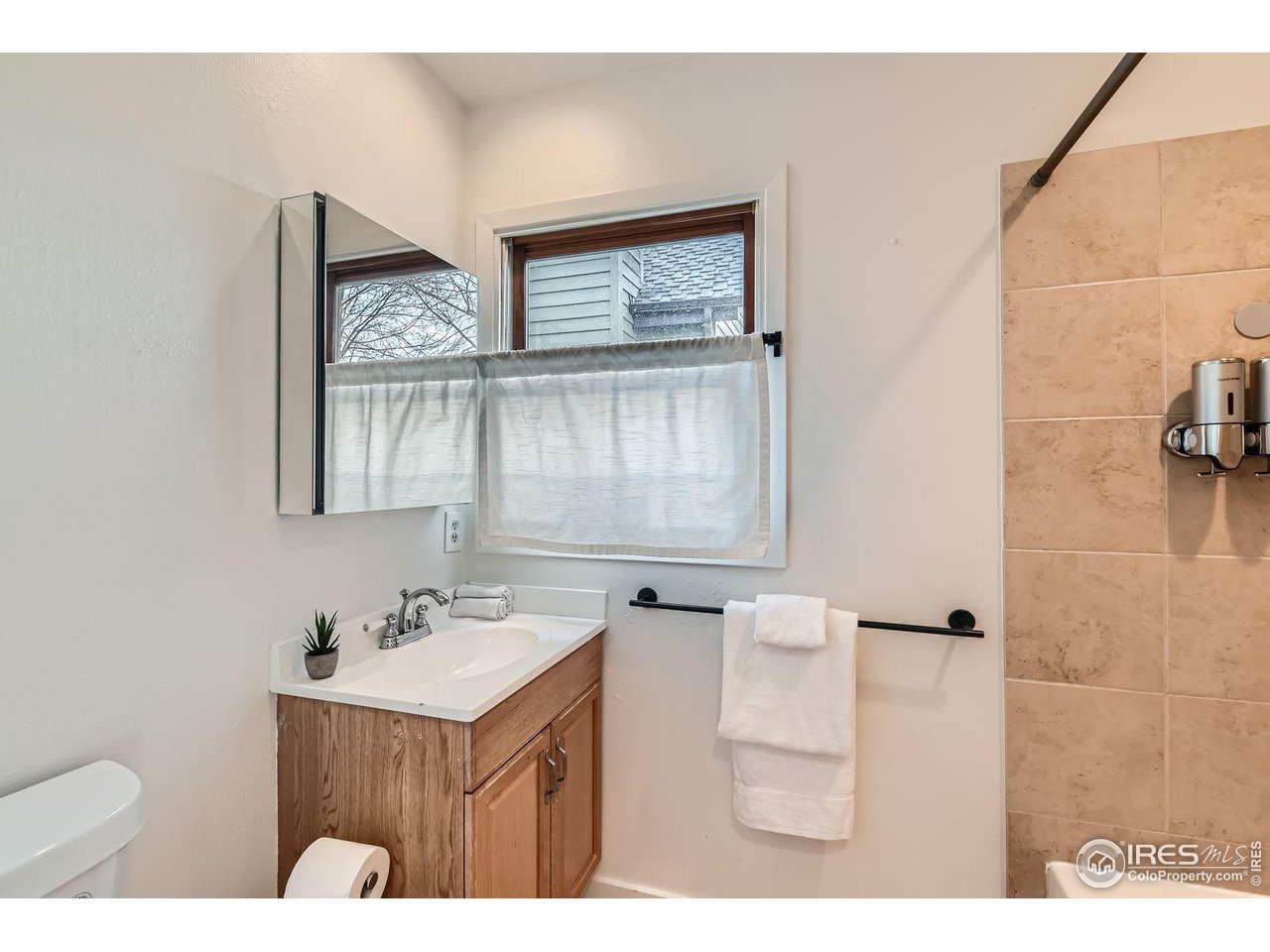 4150 Riverside Avenue Boulder, CO 80304 - Photo 10 of 40 a bathroom with a sink mirror and a toilet