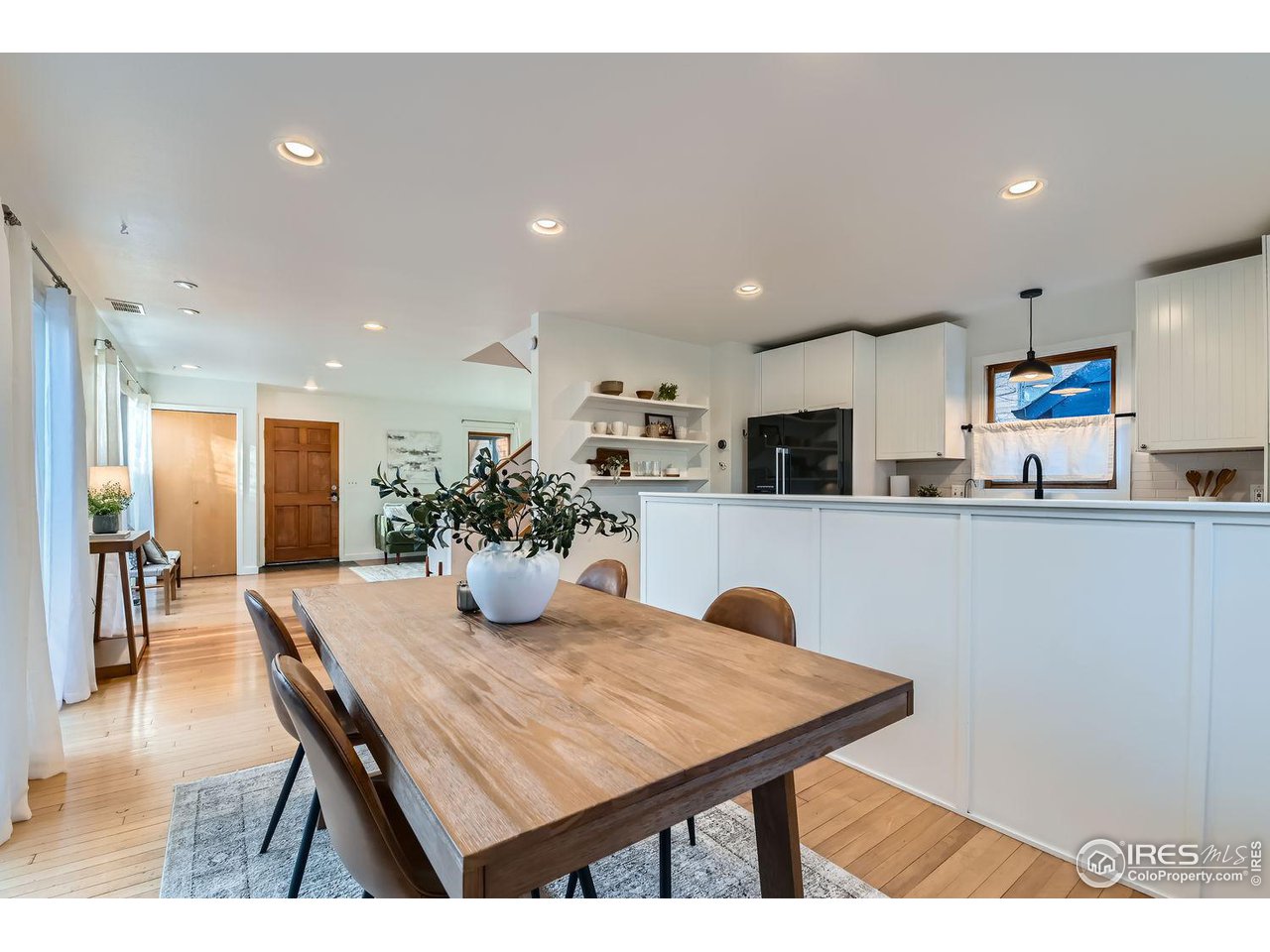 4150 Riverside Avenue Boulder, CO 80304 - Photo 35 of 40 a kitchen with stainless steel appliances kitchen island granite countertop a dining table chairs and refrigerator