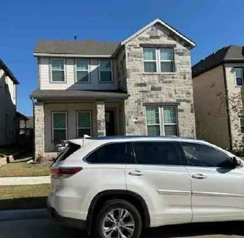 a front view of a house with parking space