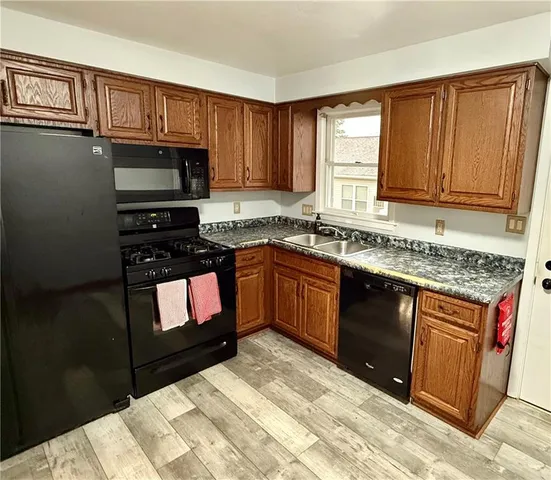 a kitchen with a sink stove top oven and cabinets