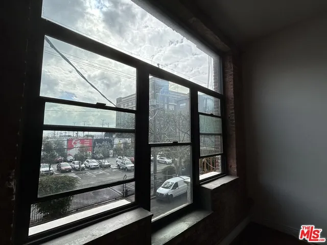 a view of a room with wooden floor and floor to ceiling window