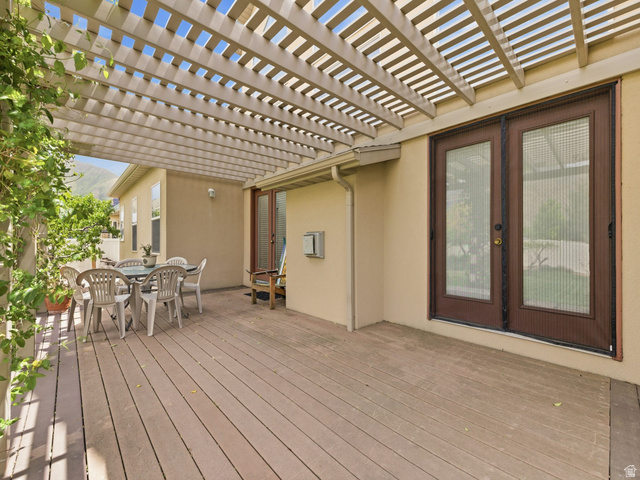 255 East 1200 North Mapleton, UT 84664 - Photo 25 of 37 Expansive outdoor deck featuring a light-colored pergola, stucco exterior, and dual French doors with screen inserts
