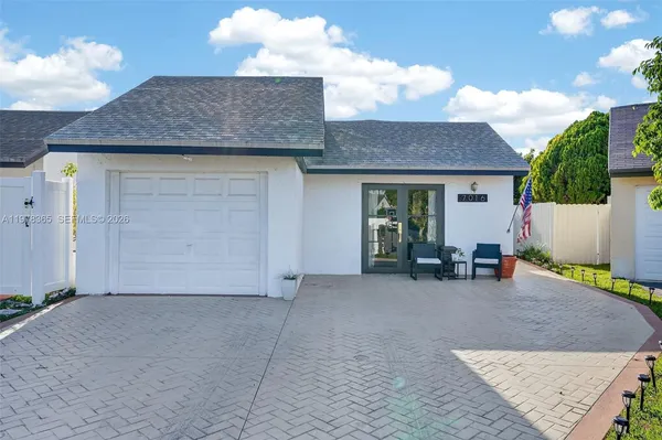a view of a house with a yard and sitting area