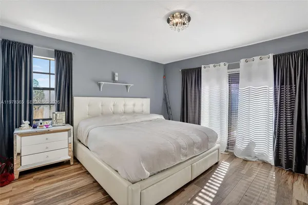 a bedroom with a bed and a large window