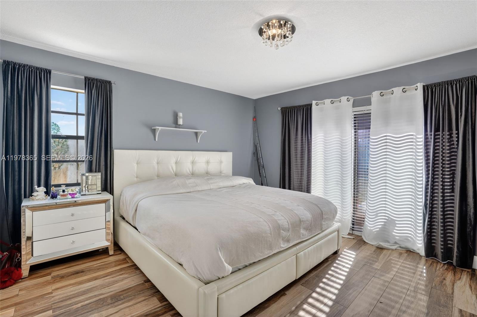 7016 Southwest 103rd Place Miami, FL 33173 - Photo 19 of 21 a bedroom with a bed and a large window