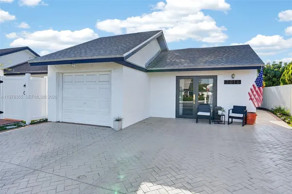 a view of house with outdoor space and sitting area