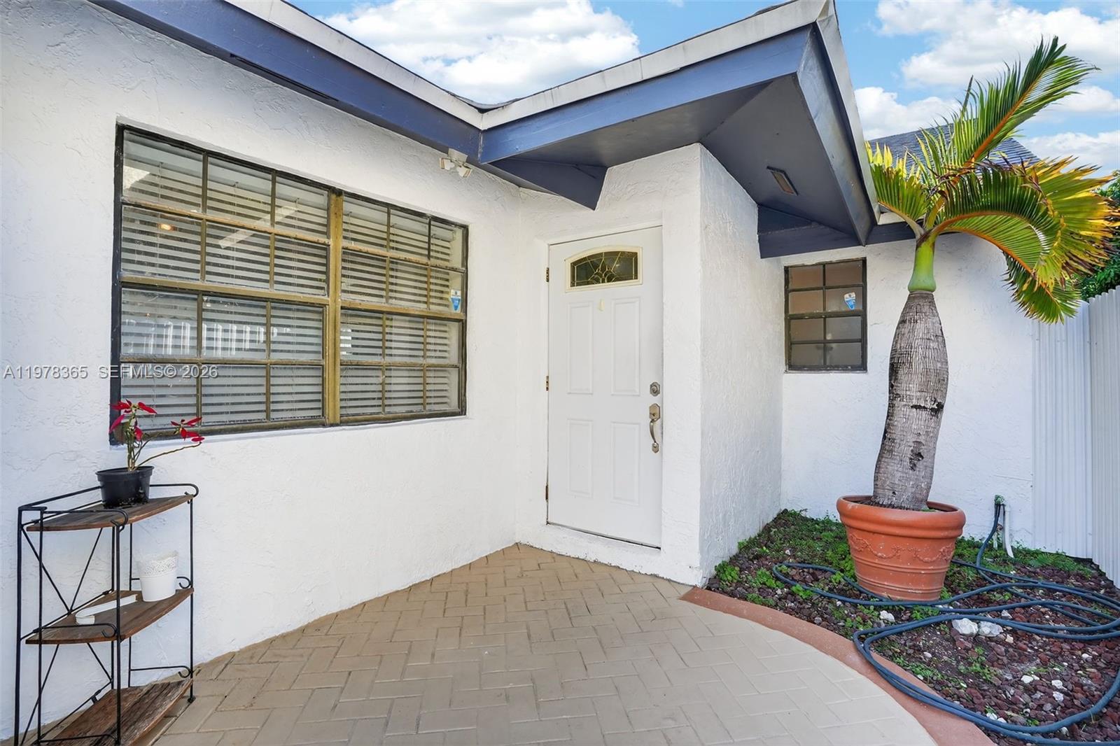 7016 Southwest 103rd Place Miami, FL 33173 - Photo 3 of 21 a house view with a seating space