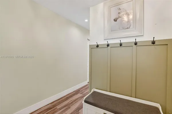 a view of a hallway with wooden floor