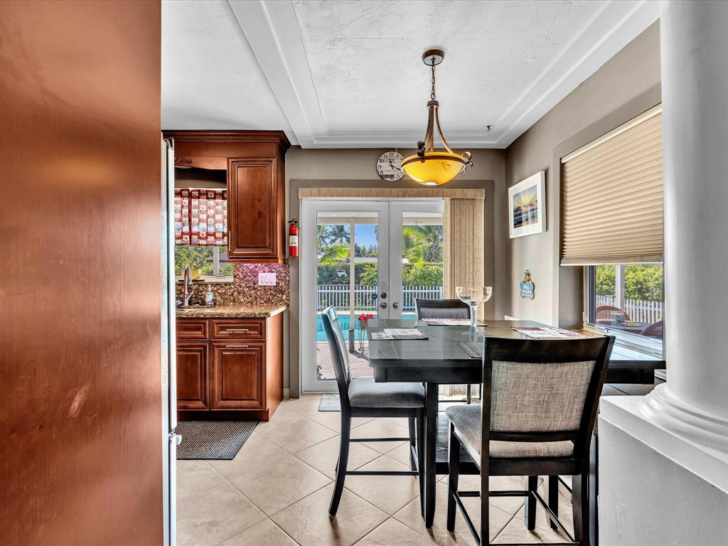 5180 Southwest 13th Street Plantation, FL 33317 - Photo 13 of 54 a dining room with furniture a chandelier and a rug