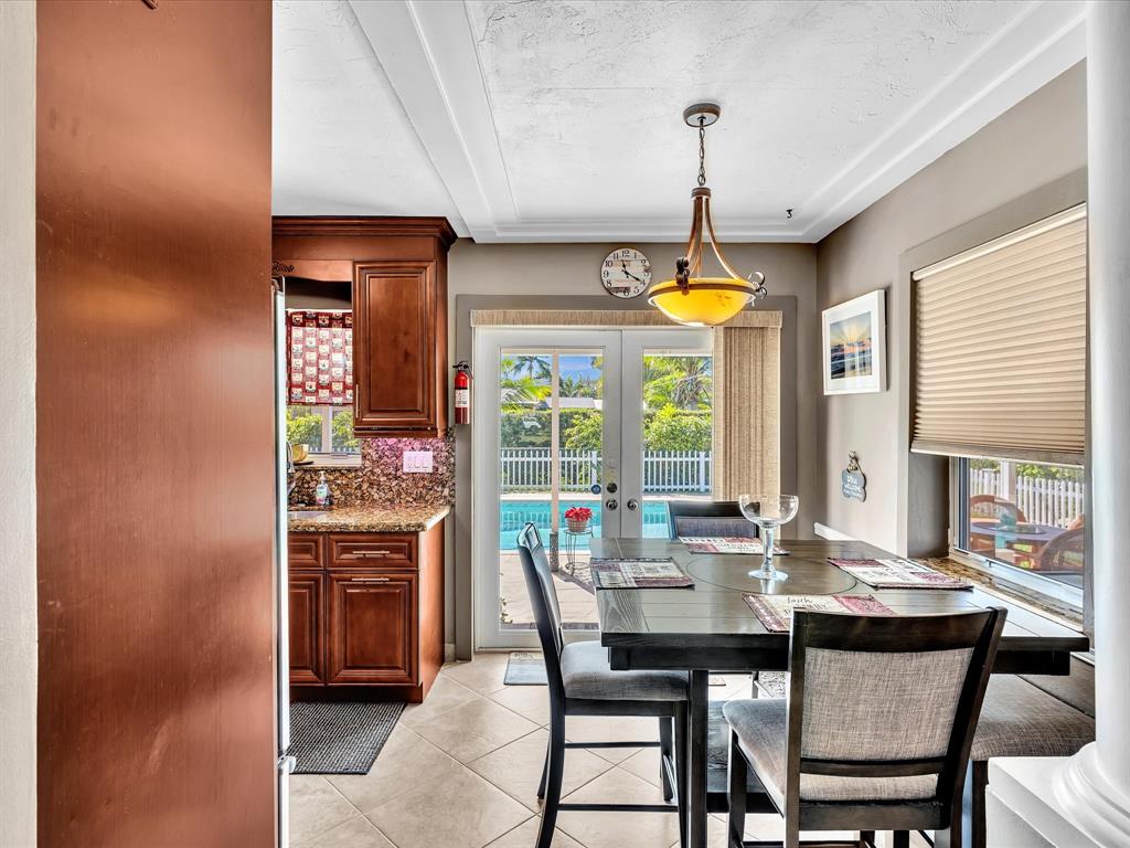 5180 Southwest 13th Street Plantation, FL 33317 - Photo 14 of 54 a dining room with furniture a chandelier and window